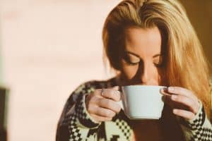 woman drinking from a mug