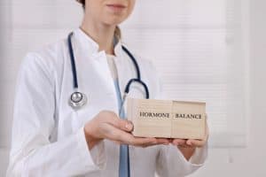 doctor holding blocks that say hormone balance
