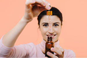 Woman Preparing to dispense CBD oil with a tincture dropper