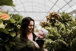 happy mother and baby in greenhouse