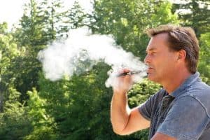 Man vaping or smoking with a CBD Vape Pen