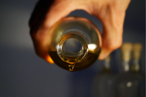 a person's hand shown pouring cbd oil out of its container