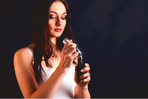 Woman refilling an e-cigarette with vape oil