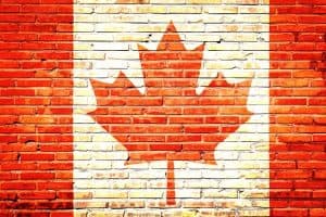 Poster of Canadian flag painted over a brick wall-like texture