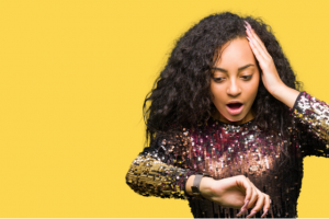 Woman surprised on looking at the time on her wristwatch